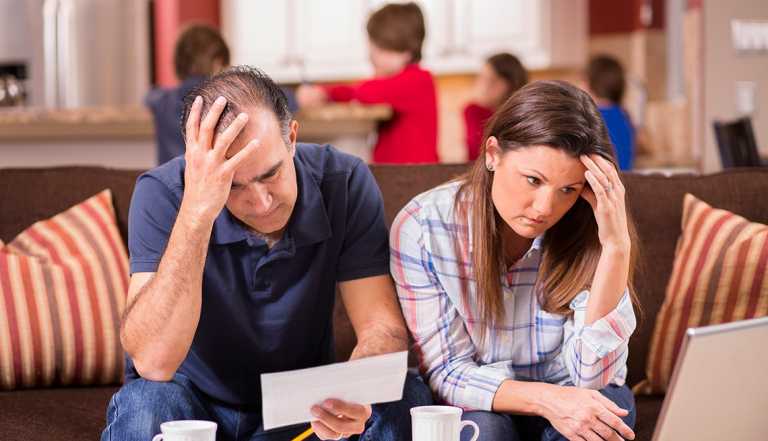 A man and woman looking down at a paper